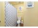 Clean bathroom with a patterned shower curtain and decorative wall art at 5125 Winding Glen Dr, Lithonia, GA 30038