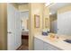Well-lit bathroom featuring a white vanity with gold fixtures and a connecting bedroom at 5125 Winding Glen Dr, Lithonia, GA 30038