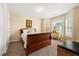 Cozy bedroom with a wooden sleigh bed, soft carpet, and a sunny bay window at 5125 Winding Glen Dr, Lithonia, GA 30038