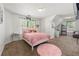 Comfortable bedroom with plush carpet, cute pink bedding, and natural light at 5125 Winding Glen Dr, Lithonia, GA 30038