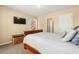 Comfortable bedroom featuring a bed with a white comforter, a TV, and neutral walls at 5125 Winding Glen Dr, Lithonia, GA 30038