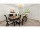 Formal dining room boasts wainscoting, a dark wood table and a chandelier at 5125 Winding Glen Dr, Lithonia, GA 30038