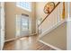 Bright foyer with wood floors, an elegant front door, and a staircase at 5125 Winding Glen Dr, Lithonia, GA 30038