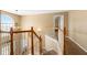 A naturally lit hallway with a view down the stairway and a decorative chandelier at 5125 Winding Glen Dr, Lithonia, GA 30038