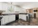 Bright eat-in kitchen with white cabinets, stone countertops, and modern appliances at 5125 Winding Glen Dr, Lithonia, GA 30038