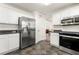 Spacious kitchen with stainless steel refrigerator and microwave, and tiled floors at 5125 Winding Glen Dr, Lithonia, GA 30038