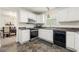 Updated kitchen featuring white cabinets, stainless steel appliances, and tiled floors at 5125 Winding Glen Dr, Lithonia, GA 30038
