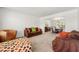 Spacious living room with neutral carpet, comfortable seating, and an open view to the dining area at 5125 Winding Glen Dr, Lithonia, GA 30038