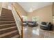 Bright living room featuring a vaulted ceiling, tile floors, and modern gray couches at 5125 Winding Glen Dr, Lithonia, GA 30038