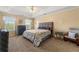 Comfortable primary bedroom with a trey ceiling and neutral-toned color palette at 5125 Winding Glen Dr, Lithonia, GA 30038