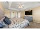 Spacious primary bedroom featuring a trey ceiling, ensuite bath, and large television at 5125 Winding Glen Dr, Lithonia, GA 30038