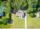 Aerial view of the home with a large green yard and a swimming pool in the neighborhood at 1015 Carriage Way, Loganville, GA 30052