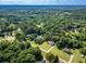 Overhead view of a neighborhood featuring the home, surrounded by lush greenery and mature trees at 1015 Carriage Way, Loganville, GA 30052