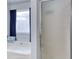Bright bathroom with tub and shower featuring modern fixtures and blue curtains at 1015 Carriage Way, Loganville, GA 30052