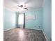 Bedroom with blue walls, ceiling fan, wood-look floors, and ample natural light at 1015 Carriage Way, Loganville, GA 30052