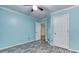 Light-blue bedroom with wood-look floors, ceiling fan and trim, with white doors at 1015 Carriage Way, Loganville, GA 30052