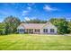 Charming home with well-maintained lawn, manicured bushes, and classic architecture on a sunny day at 1015 Carriage Way, Loganville, GA 30052