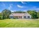Charming home with well-maintained lawn, manicured bushes, and classic architecture on a sunny day at 1015 Carriage Way, Loganville, GA 30052