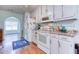 Bright kitchen area with white appliances and access to dining area at 1015 Carriage Way, Loganville, GA 30052