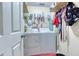 Functional laundry room with washer, dryer, and convenient shelving at 1015 Carriage Way, Loganville, GA 30052