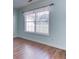 Bright, sun-filled room with laminate floors and large windows at 1015 Carriage Way, Loganville, GA 30052