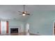 Bright living room showcasing vaulted ceiling, fan, and cozy fireplace at 1015 Carriage Way, Loganville, GA 30052