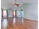 Open living room features vaulted ceilings, hardwood floors, with plenty of natural light at 1015 Carriage Way, Loganville, GA 30052