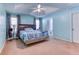 Tranquil main bedroom featuring trey ceilings, large windows, and carpeted floors at 1015 Carriage Way, Loganville, GA 30052