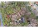 Aerial view of house surrounded by lush trees with a long driveway leading to the street at 2796 County Line Rd, Acworth, GA 30101