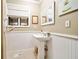 Cozy half bathroom featuring wainscoting, a pedestal sink, and a window with a blind at 2796 County Line Rd, Acworth, GA 30101