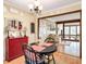 Charming dining area featuring a round table, red accent cabinet, and an open doorway to an adjacent room at 2796 County Line Rd, Acworth, GA 30101
