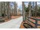 Concrete driveway leading up to the house with split rail fence at the property line at 2796 County Line Rd, Acworth, GA 30101