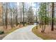 View of the ranch style home with a long concrete driveway leading to the two-car garage at 2796 County Line Rd, Acworth, GA 30101