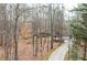 Exterior shot of the property featuring a long concrete driveway leading up to the house at 2796 County Line Rd, Acworth, GA 30101