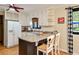Well-lit kitchen featuring a breakfast bar with seating and a window overlooking the backyard at 2796 County Line Rd, Acworth, GA 30101