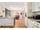 Updated kitchen with white cabinets, a breakfast bar, stainless appliances, and an adjacent dining area at 2796 County Line Rd, Acworth, GA 30101
