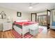 Bright main bedroom features a ceiling fan, a striped rug, and access to the sun room through french doors at 2796 County Line Rd, Acworth, GA 30101