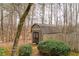 View of the back yard shed with a brown exterior, wooden frame, and shingled roof at 2796 County Line Rd, Acworth, GA 30101