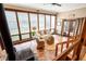 Bright sunroom featuring large windows, tile floor, wood stove and comfortable seating at 2796 County Line Rd, Acworth, GA 30101