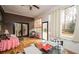 Bright sunroom with outdoor views, wood floors, and versatile seating arrangements at 2796 County Line Rd, Acworth, GA 30101