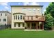 Two-story home backyard with a wooden deck and a grass lawn, surrounded by green trees at 3086 Frazier Walk, Decatur, GA 30033