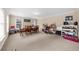 Spacious basement with dining set, shelving and carpet flooring at 3086 Frazier Walk, Decatur, GA 30033