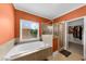 Bright bathroom featuring soaking tub, glass shower, and access to walk-in closet at 3086 Frazier Walk, Decatur, GA 30033