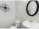 Bathroom features a white toilet and pedestal sink with an oval mirror at 3086 Frazier Walk, Decatur, GA 30033
