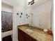 Bathroom featuring granite countertop, dark wood cabinets, and shower-tub combo at 3086 Frazier Walk, Decatur, GA 30033