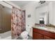 Cozy bathroom features a shower and tub combination with stylish shower curtain and vanity with granite countertop at 3086 Frazier Walk, Decatur, GA 30033