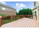 A beautifully crafted wooden deck is complemented by lush greenery and a clear blue sky at 3086 Frazier Walk, Decatur, GA 30033