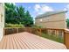 A sprawling deck with brown railings is perfect for entertaining and enjoying nature's serenity at 3086 Frazier Walk, Decatur, GA 30033