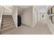 Hallway showcasing carpeted stairs, neutral paint, and an inviting view of the backyard through the door at 3086 Frazier Walk, Decatur, GA 30033