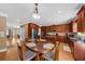 Kitchen boasts stainless steel appliances, granite countertops and wood cabinets with an adjacent dining area at 3086 Frazier Walk, Decatur, GA 30033